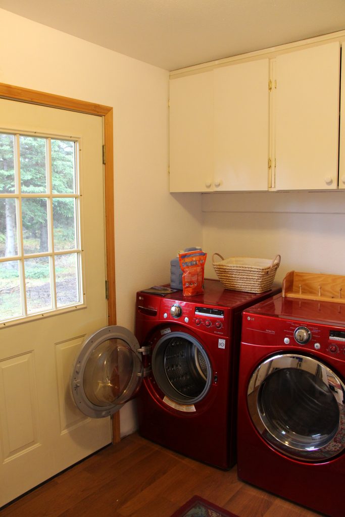 A red washer and dryer in a room.